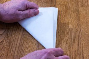 Step 3: Fold your cartouche paper again forming a square. Step 3: Fold your cartouche paper again forming a triangle.