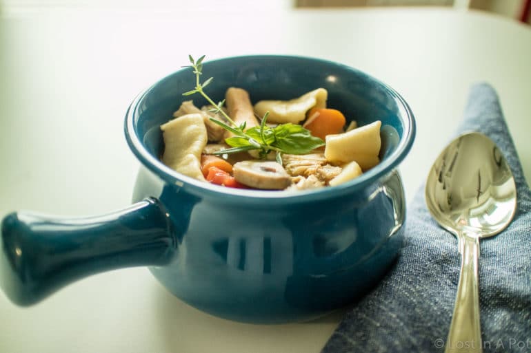 A bowl of Homemade Vegetable & Chicken Soup with Fresh Noodles.