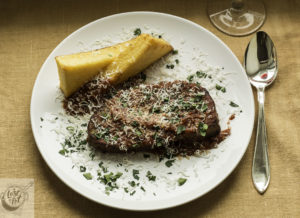 Plated Italian Meatloaf with Polenta and Spicy Sauce. Plated Italian Meatloaf with Polenta and Spicy Sauce.