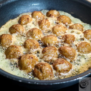 Meatballs frying.