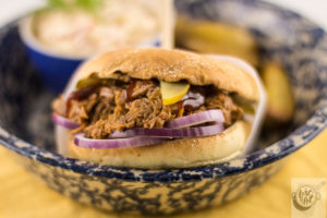 Pulled pork sandwich, all dressed and ready to eat. Pulled pork sandwich, all dressed and ready to eat.