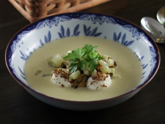 A bowl of mussel soup with smoked fresh cheese and sautéed fennel. A bowl of mussel soup with smoked fresh cheese and sautéed fennel.