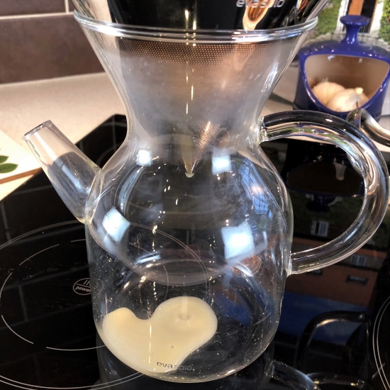 Mussel stock straining through a coffee filter. Mussel stock straining through a coffee filter.