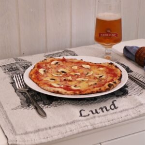 A Swedish capricciosa pizza, on a plate. A Swedish capricciosa pizza, on a plate.